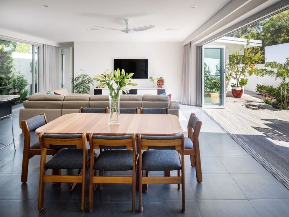 beautiful sunny living room with a wooden table at the centre